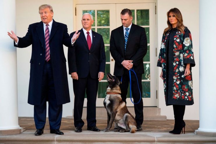 US President Donald Trump (L), Vice President Mike Pence (2nd L) and First Lady Melania Trump (R) stand with Conan, the military dog that was involved with the death of ISIS leader Abu Bakr al-Baghdadi, at the White House in Washington, DC, on November 25, 2019. (Photo by JIM WATSON / AFP) (Photo by JIM WATSON/AFP via Getty Images)